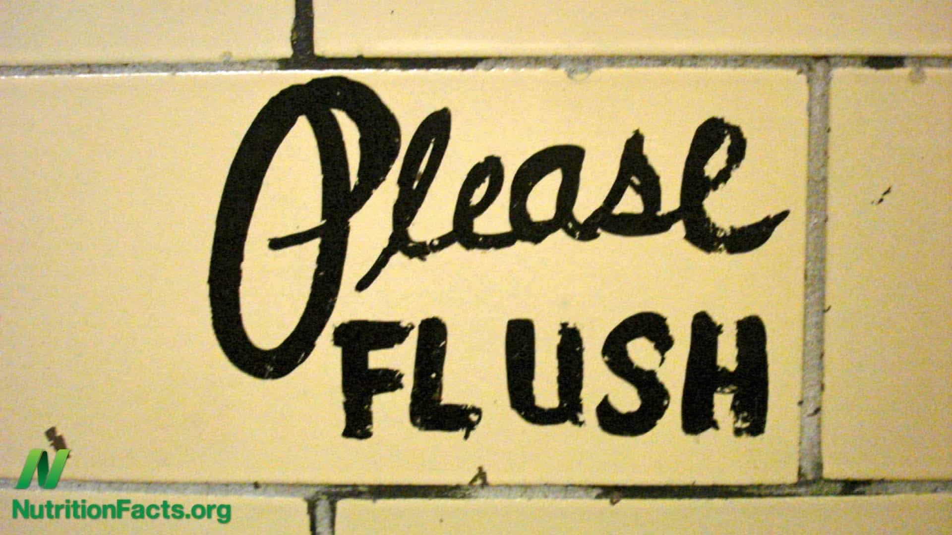 "please flush" written on a wall