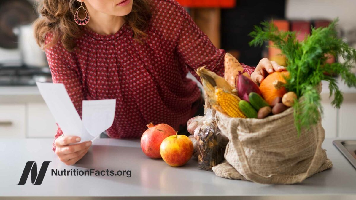woman holding receipt next to bag of product