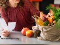 woman holding receipt next to bag of product