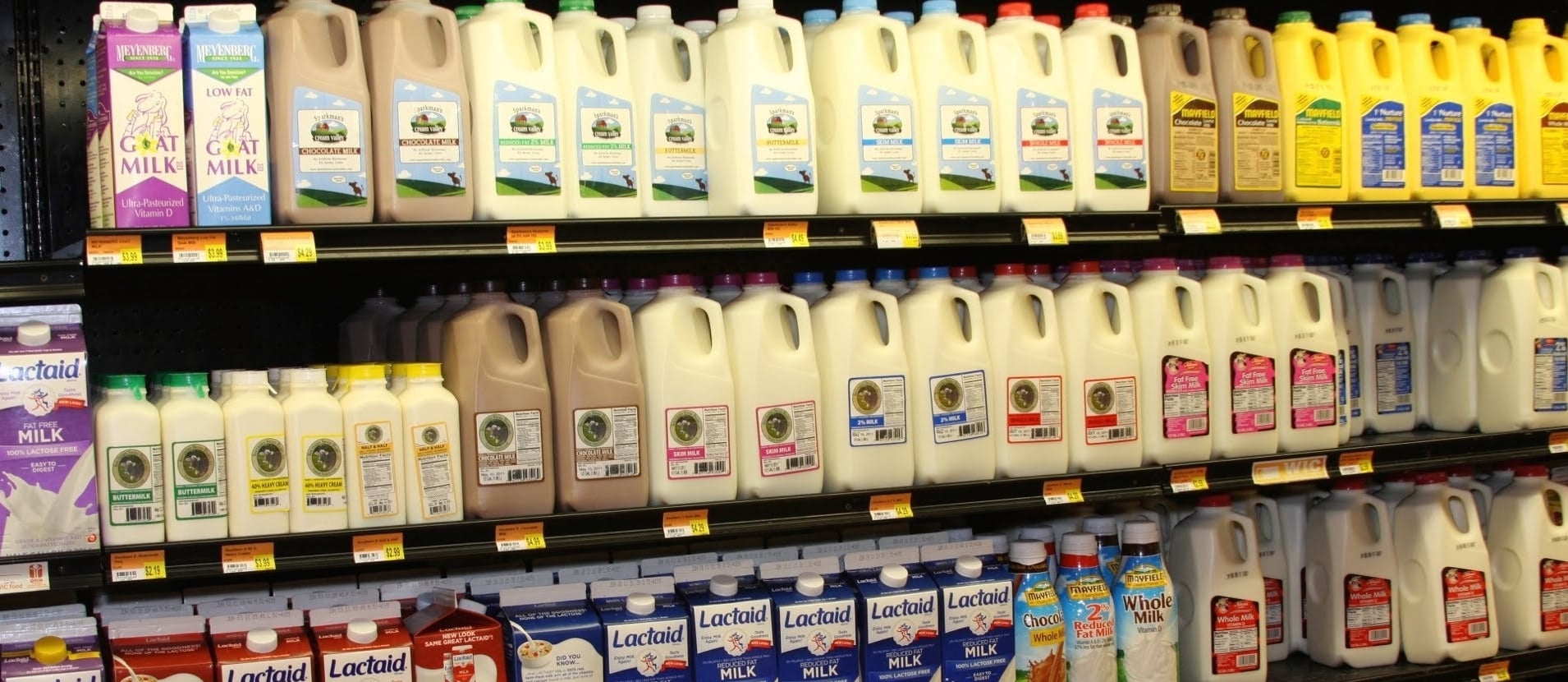 shelves of various cartons and bottles of milk