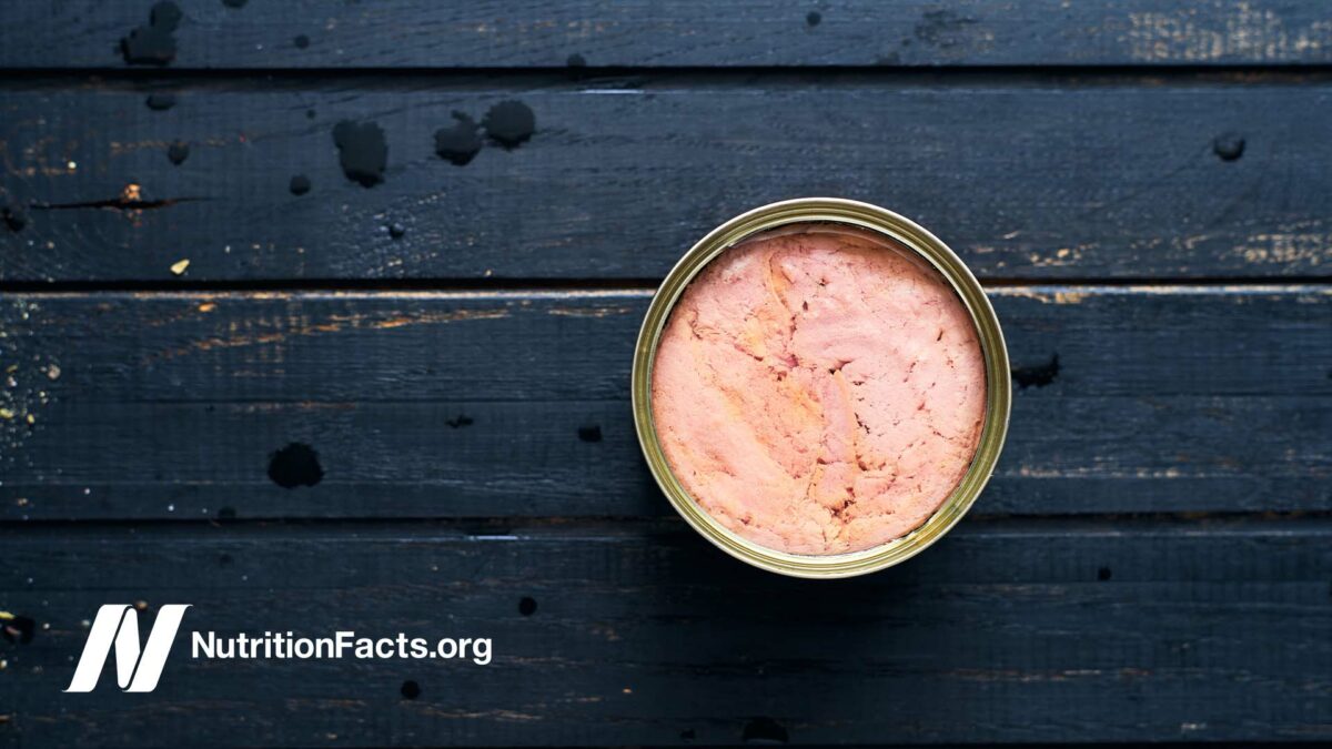 can of tuna on a black background