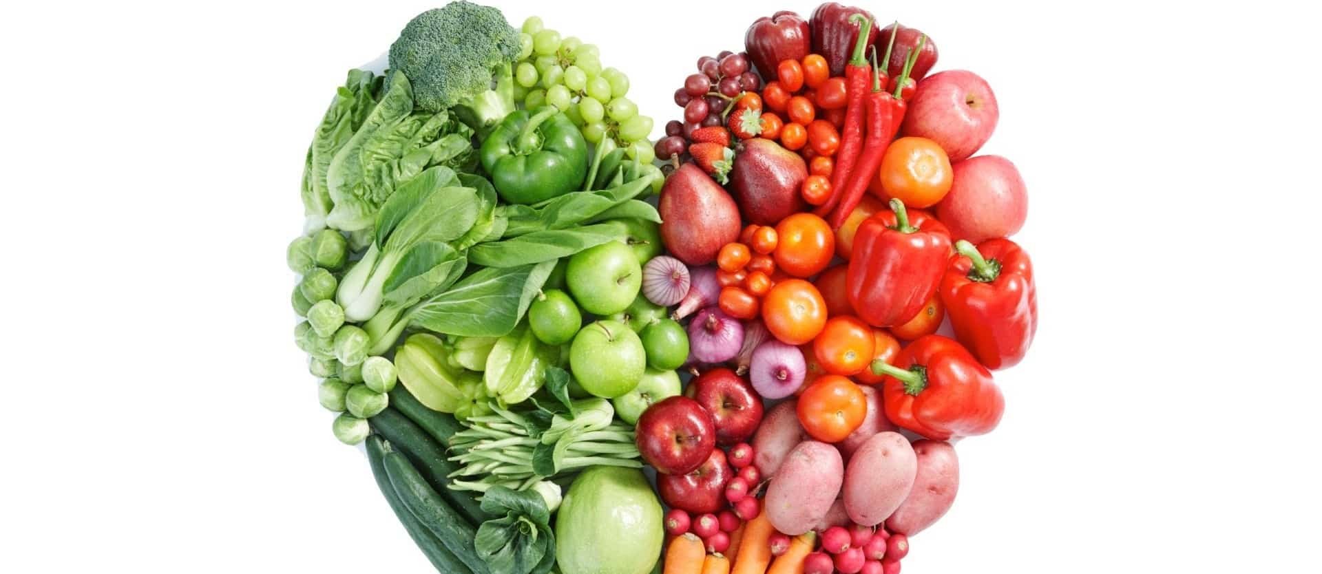 various fruits and vegetables arranged into a heart shape