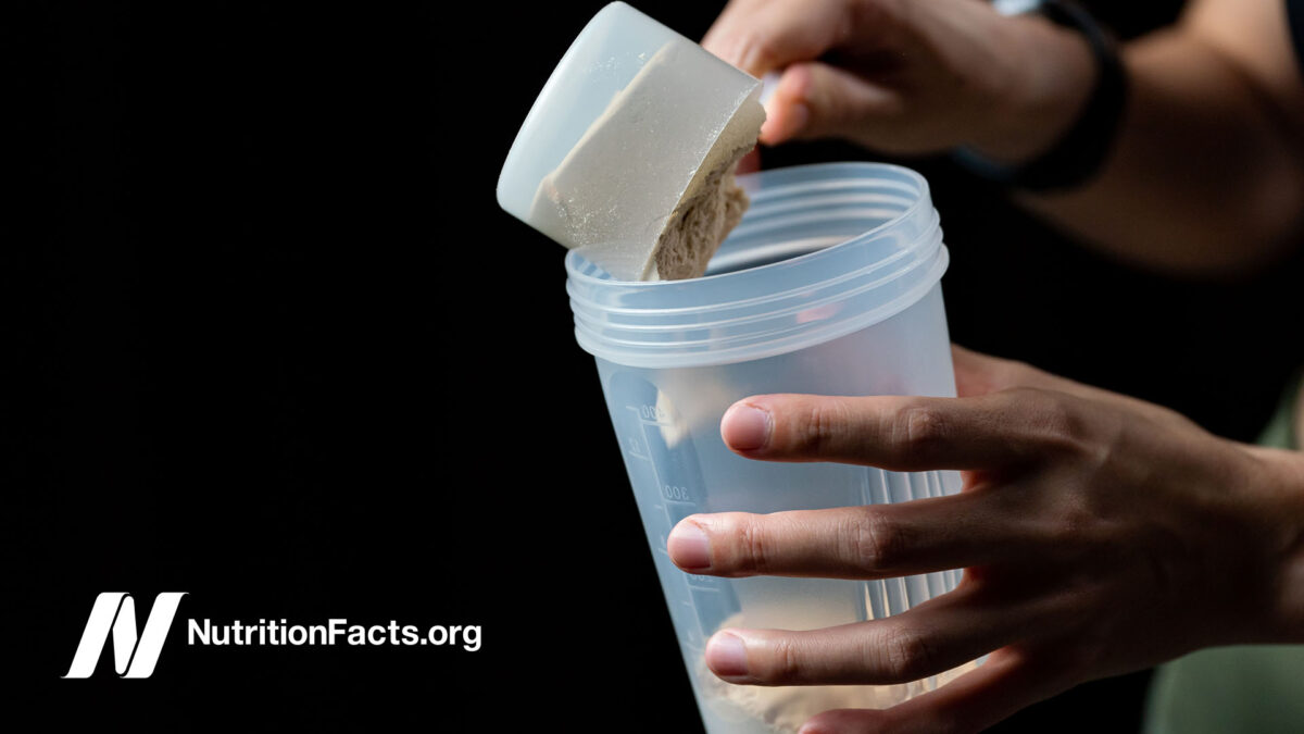 person putting protein powder into a cup