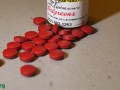 iron supplements laying on a surface in front of its container