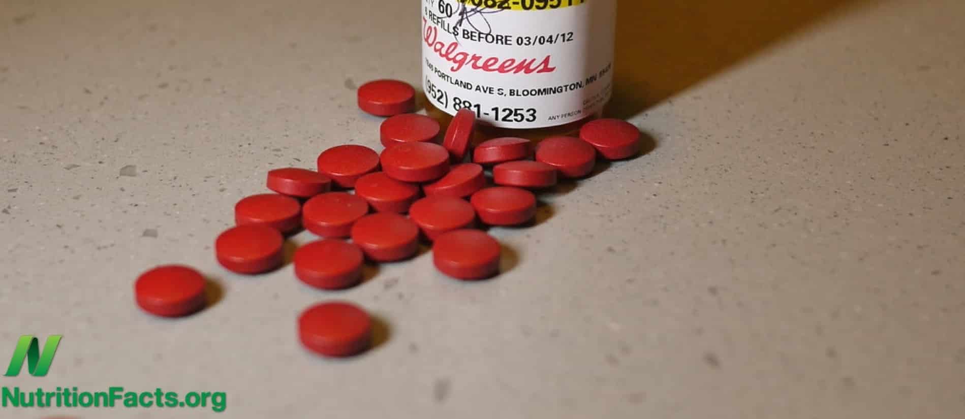 iron supplements laying on a surface in front of its container