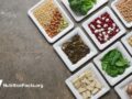 small plates of various vegetables, legumes, nuts, and seeds