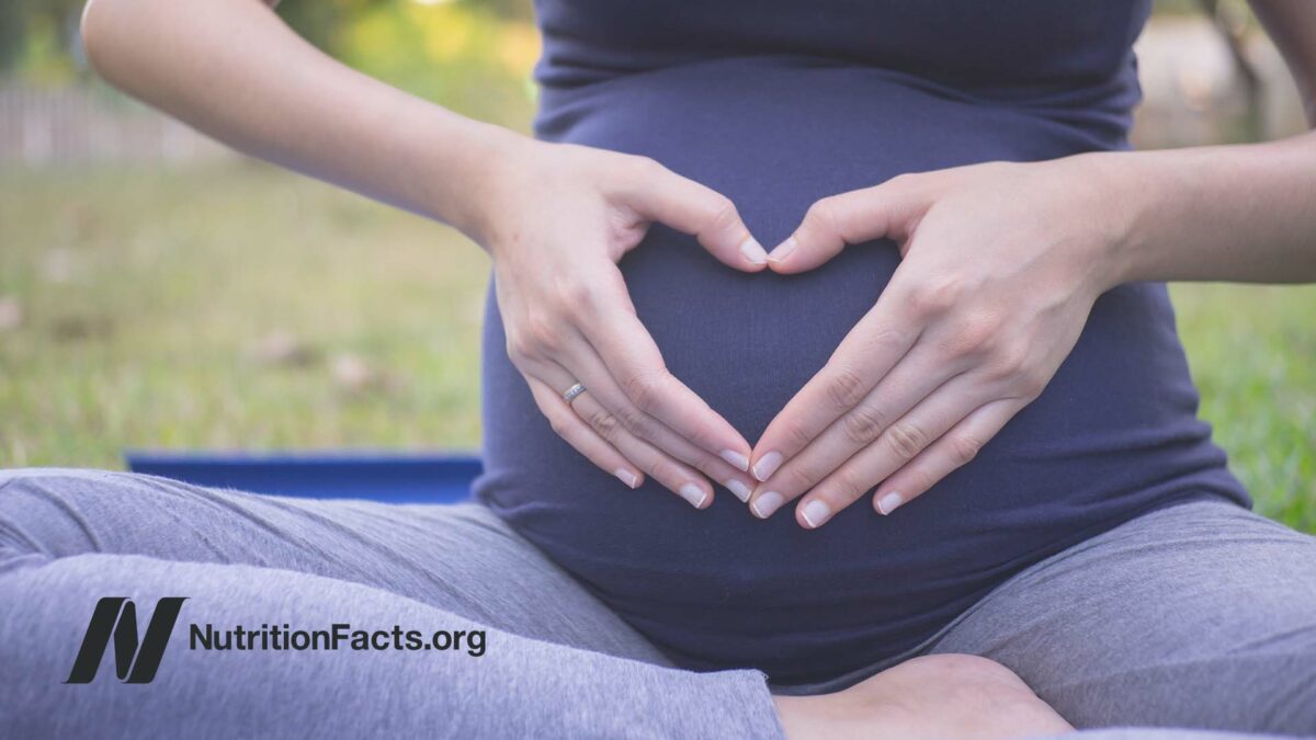 pregnant woman with hands on belly