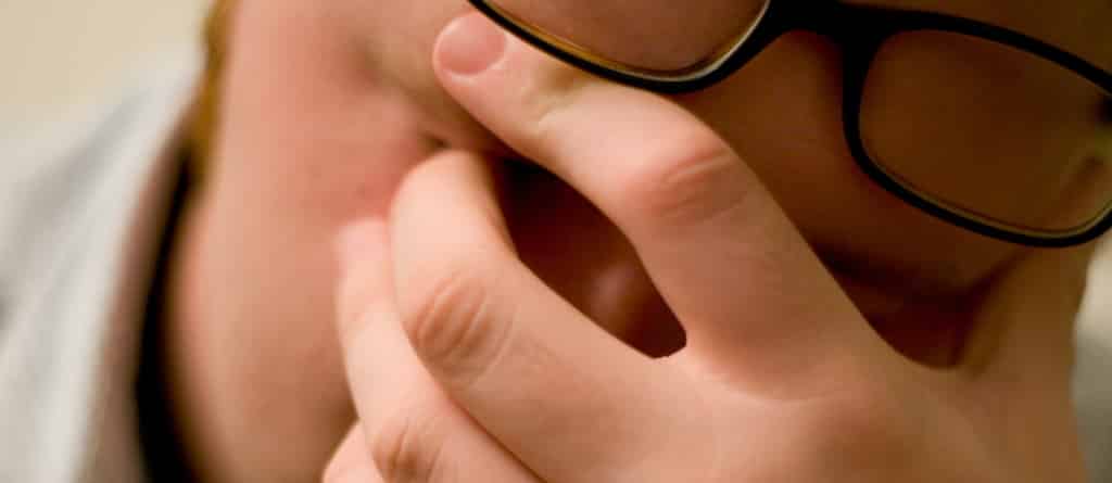 person with their hand on their head