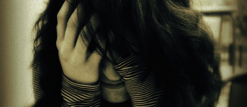 person with their head in their hands