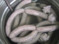 pot filled with water and sausages