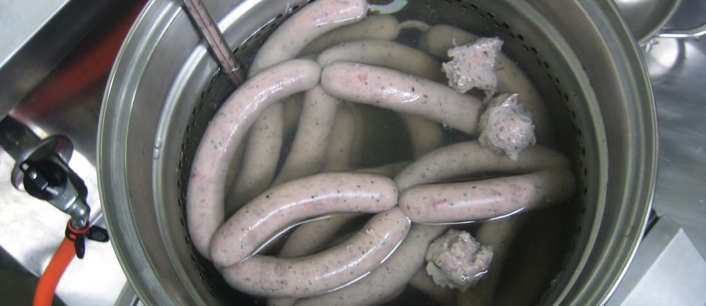 pot filled with water and sausages