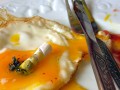 fried egg with a cigarette stump on top