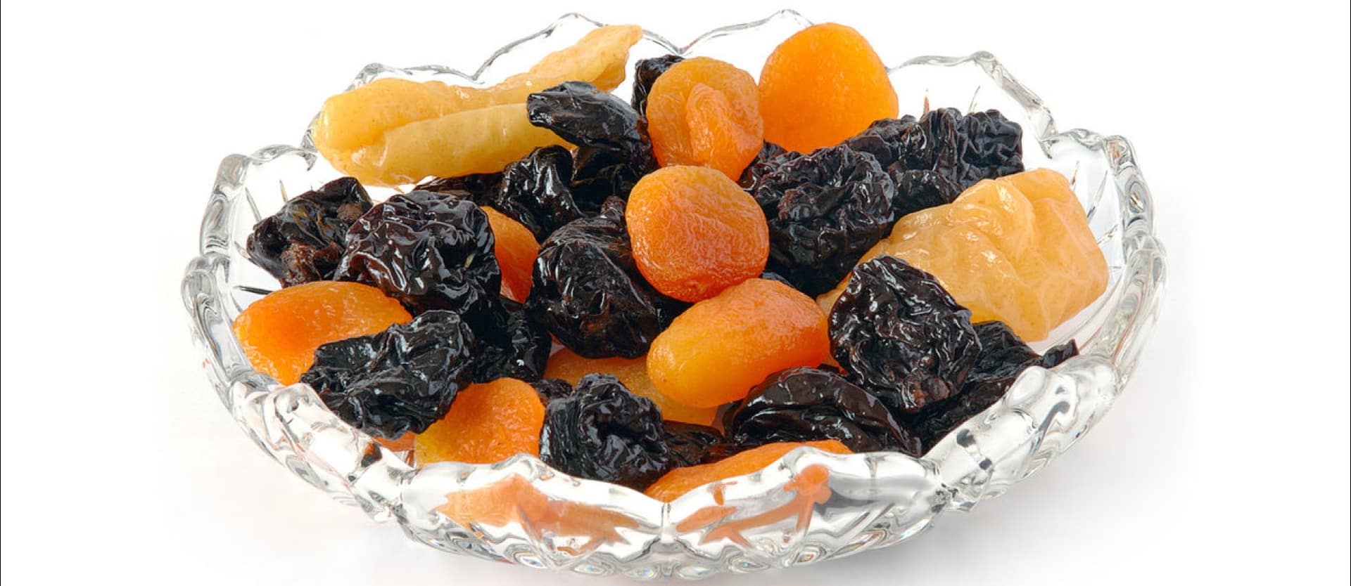crystal bowl of dried prunes and apricots