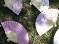 six pink paper fans on grass