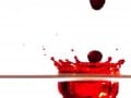 drops of red food dye splashing onto a surface