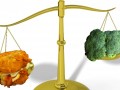 weight scale with fried food on one side and broccoli on the other