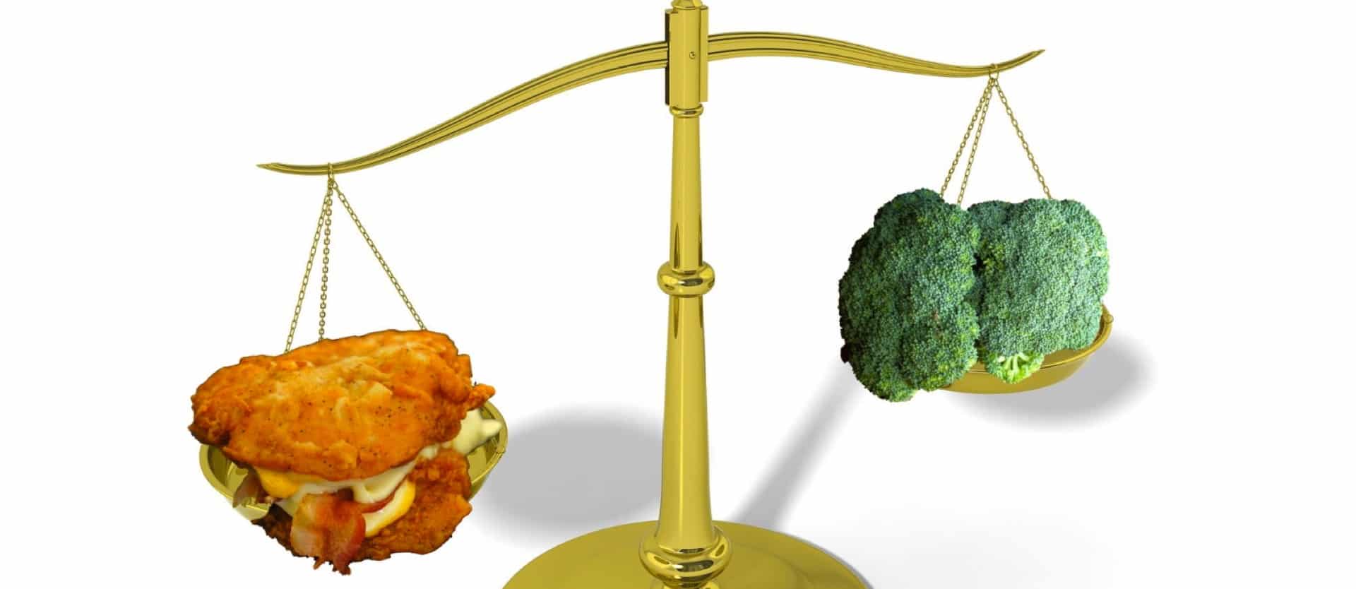 weight scale with fried food on one side and broccoli on the other