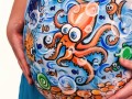 pregnant belly with drawings of underwater animals on it