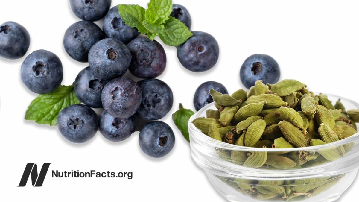 blueberries with sprigs of mint and a ramekin of cardomom pods