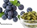 blueberries with sprigs of mint and a ramekin of cardomom pods