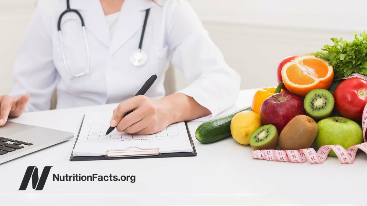 a doctor next to pile of produce