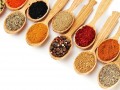 wooden spoons filled with various herbs and spices