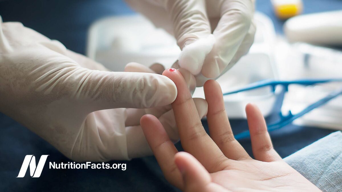 nurse pricking patient finger