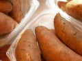 plastic containers filled with whole sweet potatoes