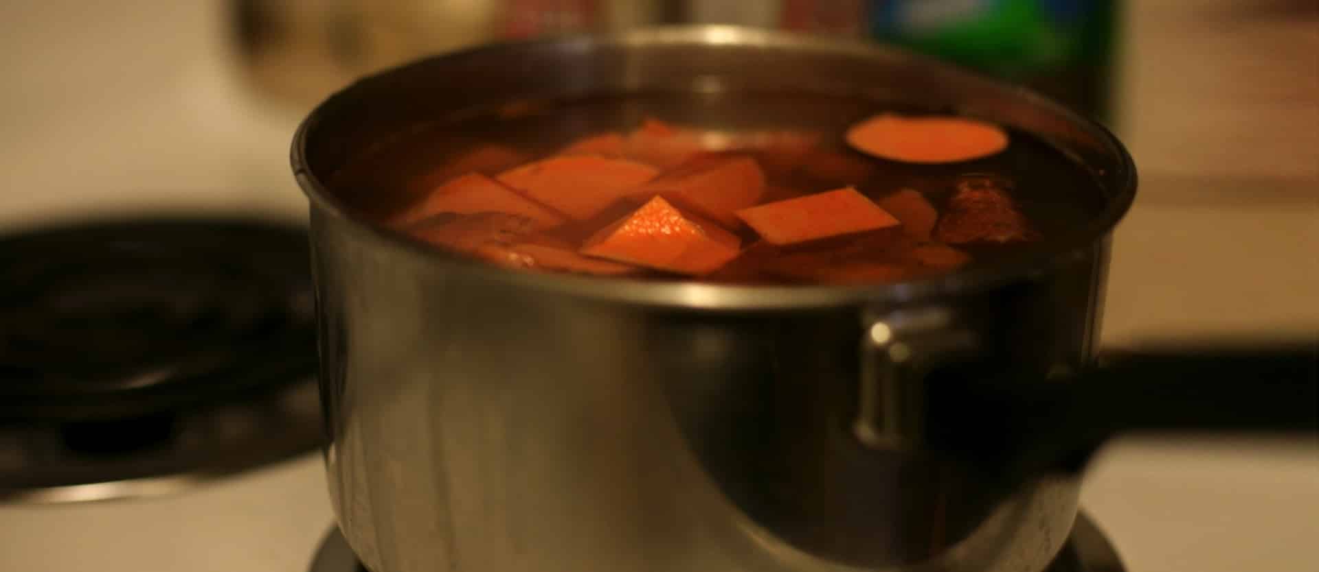 pot filled with water and chopped sweet potatoes