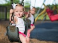 children sitting in swings