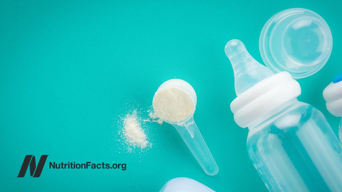 bottle and formula powder on turquoise background