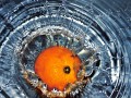 orange splashing in warer