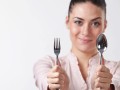 woman holding a fork and spoon