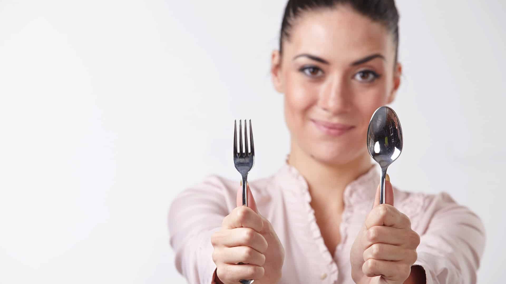 woman holding a fork and spoon