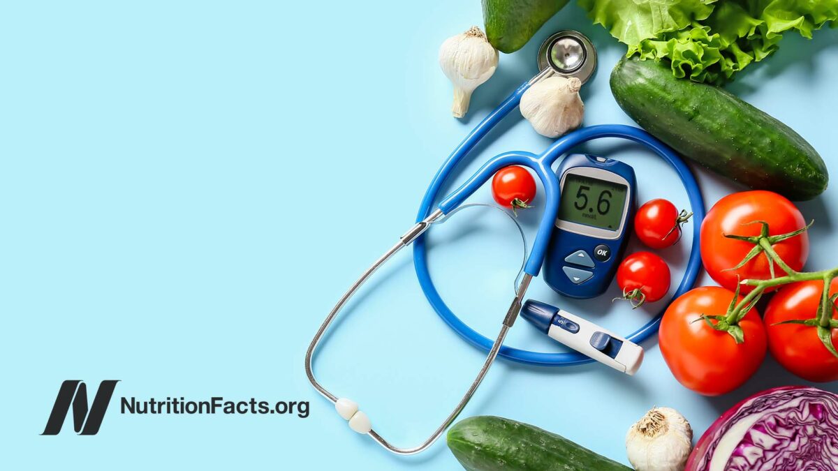 blood glucose monitor and insulin shot surrounded by various vegetables
