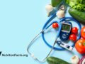blood glucose monitor and insulin shot surrounded by various vegetables