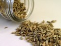 jar tipped over with fennel seeds spilling out
