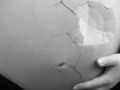 pregnant belly with a cracked eggshell effect