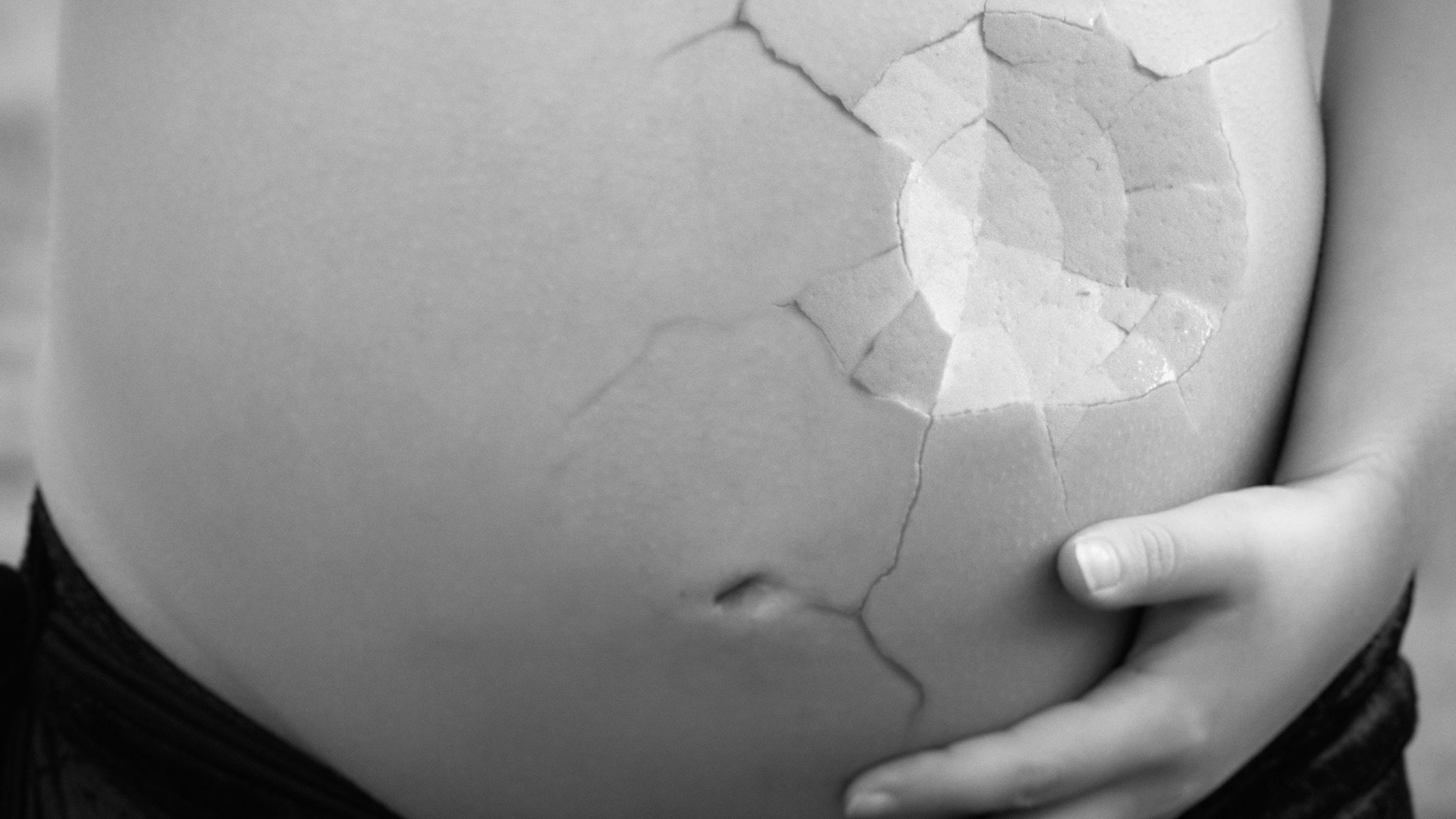 pregnant belly with a cracked eggshell effect