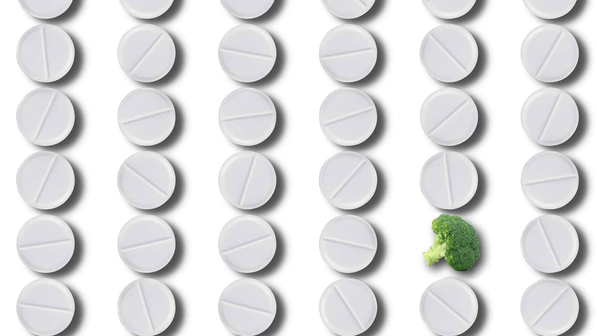 rows of tablets with one broccoli floret