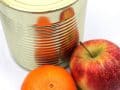 tin can with apples next to it