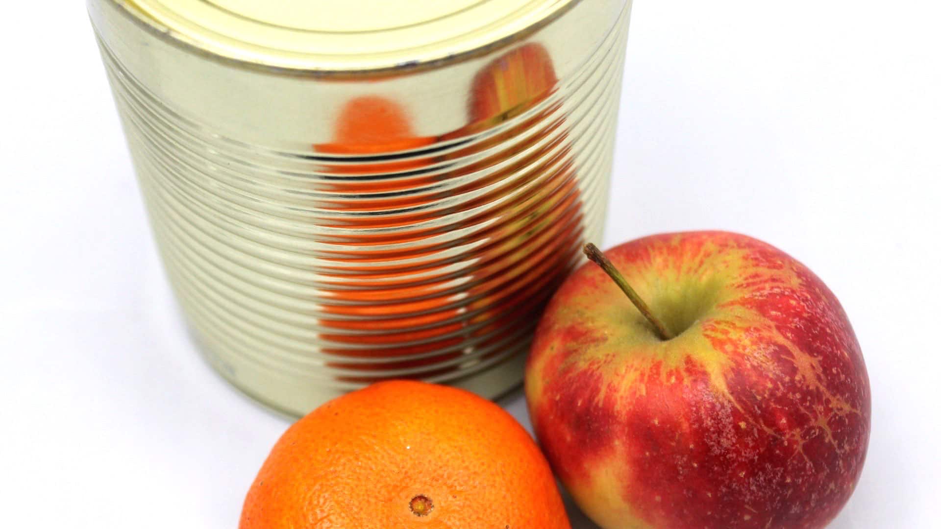 tin can with apples next to it