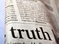 close up of a newspaper article with the word "truth" in its heading