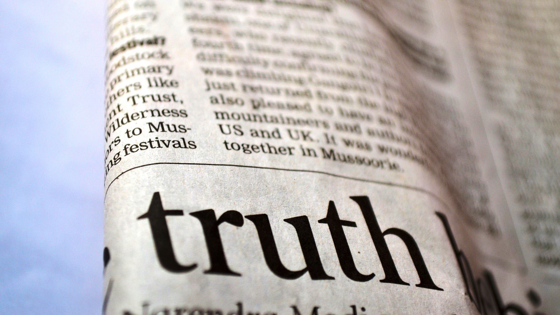 close up of a newspaper article with the word "truth" in its heading