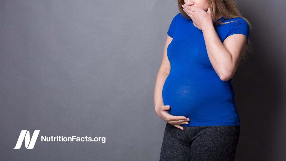pregnant woman looks nauseated