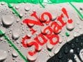 close of the words "no sugar" on a soda can