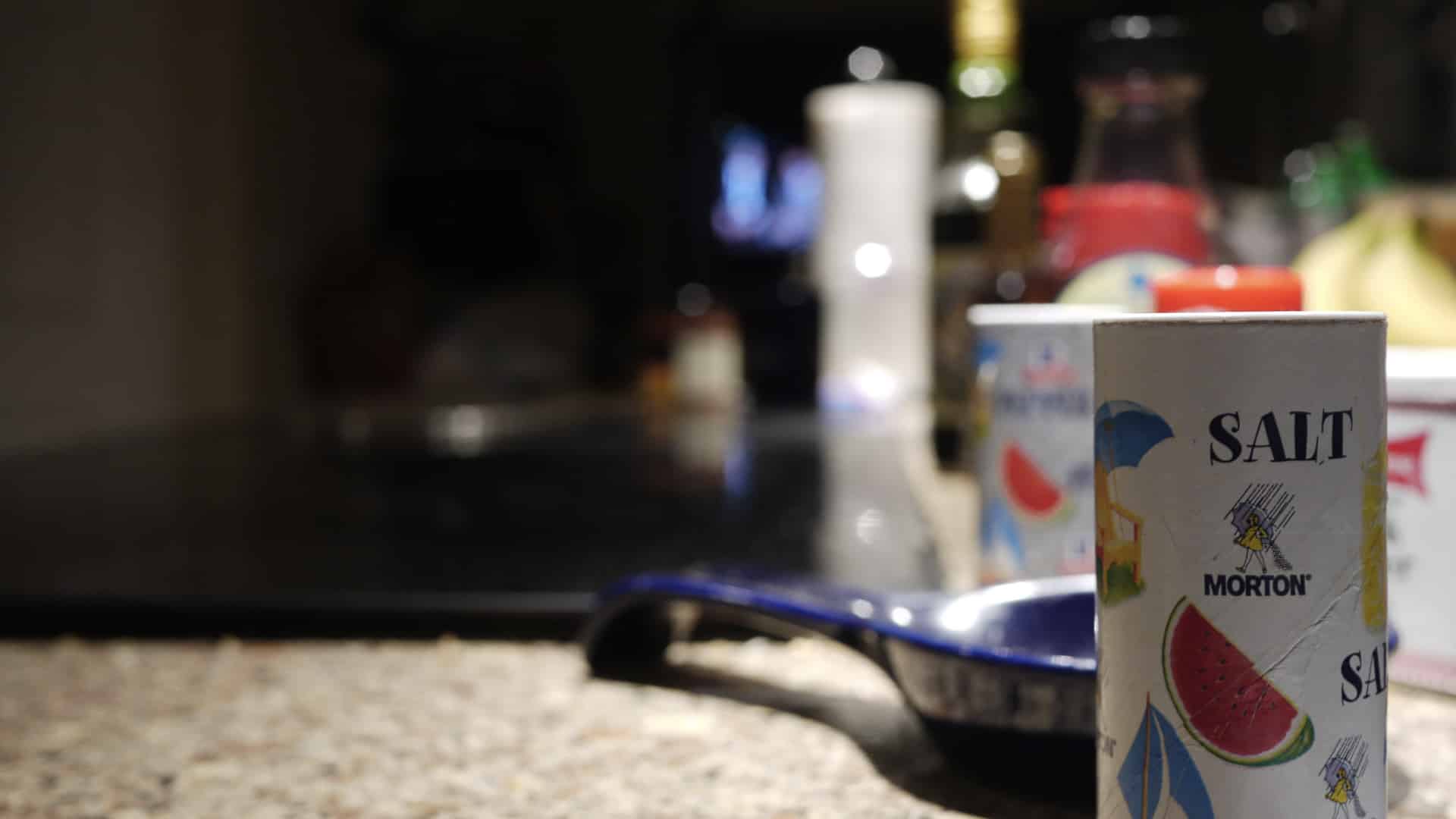 container of salt on a kitchen counter
