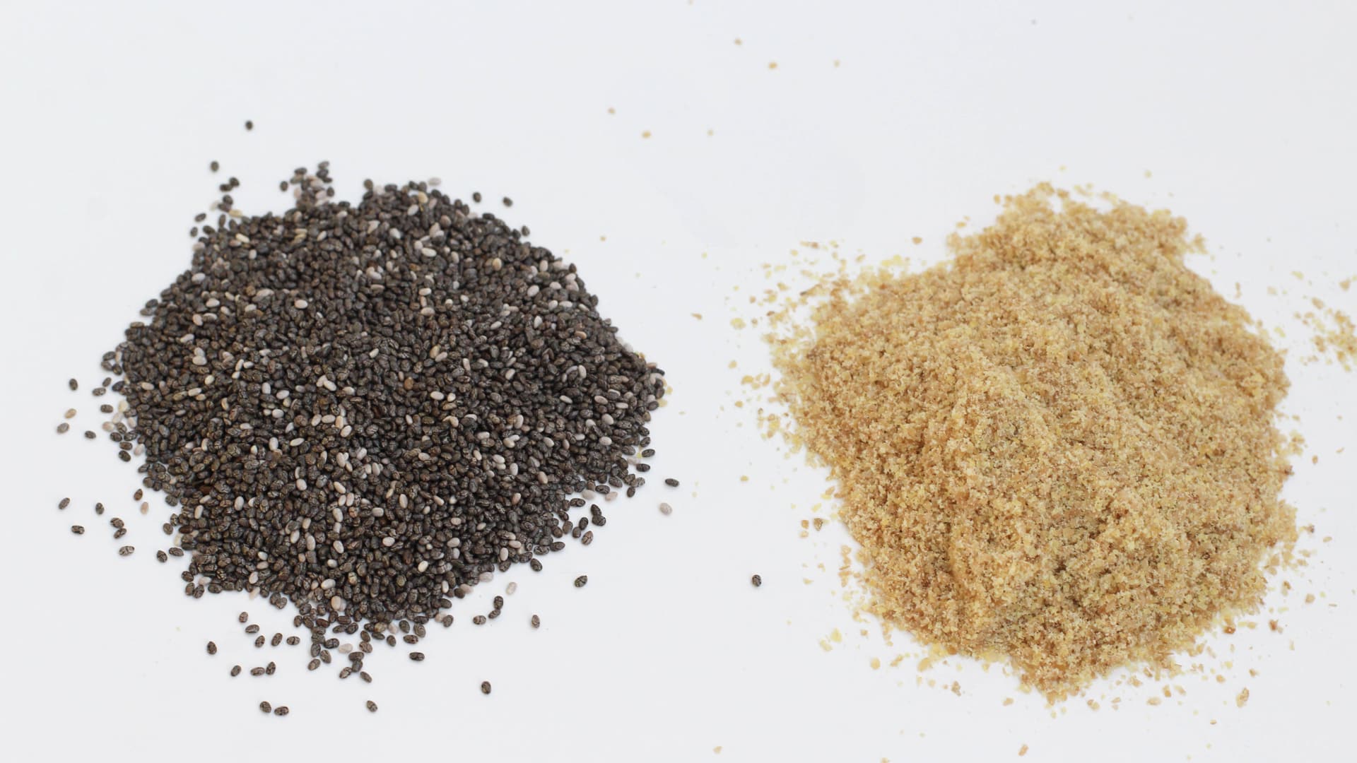 a small mound of chia seeds and of flax seeds