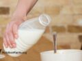 hand holding bottle of milk