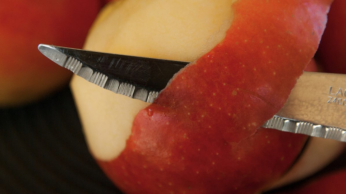 apple being peeled with a knife